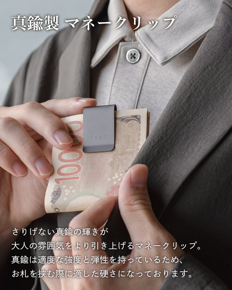 男性がジャケットの胸ポケットに紙幣を挟んだ真鍮製マネークリップを差し込む使用シーンで、大人の雰囲気を演出する着用例。