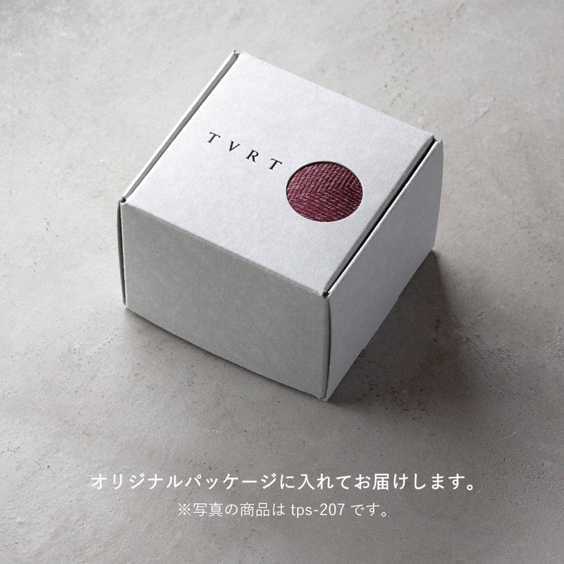 ネクタイの包装方法についての画像 落ち着いたグレーの窓付き箱に梱包されている。TVRTの箔押しロゴが印字されている。